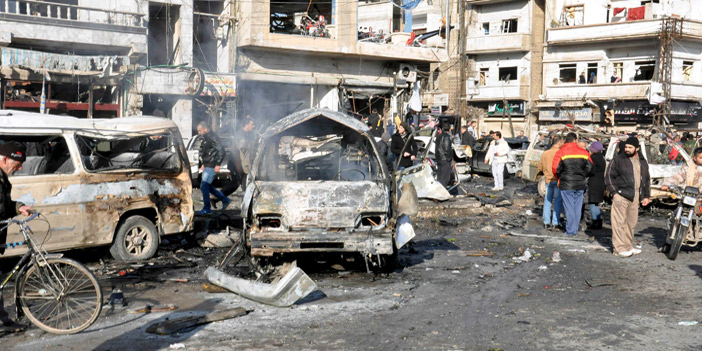  آثار التفجيرين الانتحاريين اللذين استهدفا نقطة تفتيش لجيش الأسد في حمص