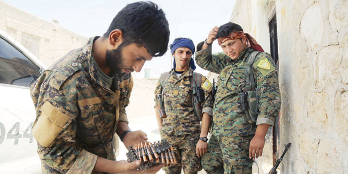  جنديان من قوات سوريا الديمقراطية يستعدان لمواجهة داعش في منبج