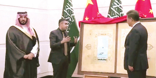  الأمير محمد والرئيس الصيني تتوسطهم اللوحة والفنان أحمد ماطر