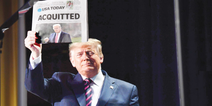  ترامب مُحتفياً ببراءته رافعاً نسخة ورقية من صحيفة «يو إس توداي» أمس الخميس