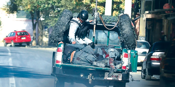  نقل القتلى من عناصر الشرطة الأفغانية الذين سقطوا في الانفجارين قرب وزارة الدفاع